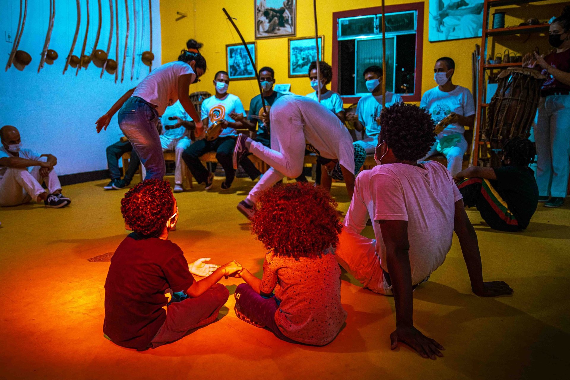 Children hold hands during Capoeira class in Salvador.